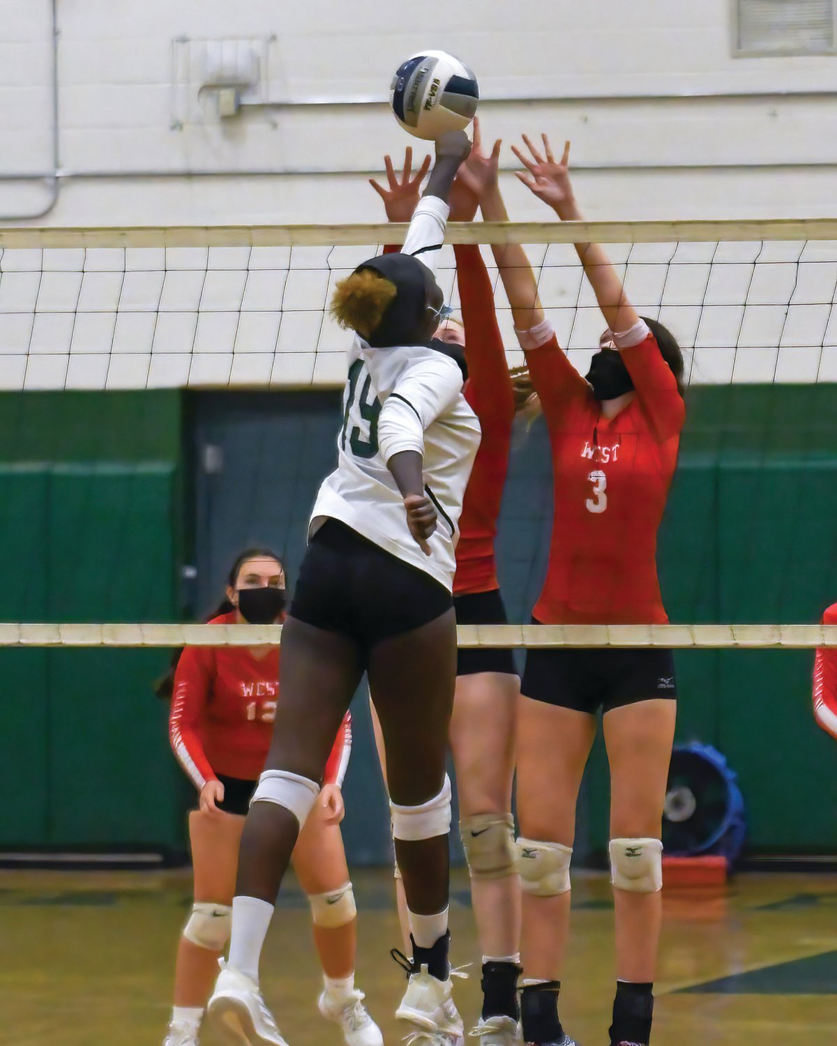 AT THE NET: West’s Eve Anthony jumps to block a shot.
